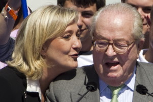 epa03202562 French far-right National Front (FN) political party leader Marine Le Pen (L) speaks with her father Jean-Marie Le Pen (R), as they hold their annual May Day Nation Front rally in Paris, France 01 May 2012. Marine Le Pen stated that she does not intend to endorse Nicolas Sarkozy or Francois Hollande in the second round of the French Presidential election to be held on 06 May.  EPA/IAN LANGSDON