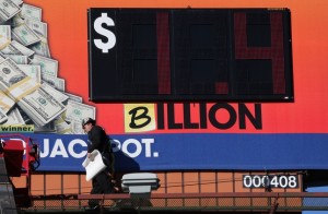 Tim Baldwin walks off after adding the letter "B" to a Georgia Lottery billboard Monday, Jan. 11, 2016, in Atlanta. The Powerball jackpot has grown to over 1 billion dollars, and the drawing is still two days away. (Ben Gray/Atlanta Journal-Constitution via AP) MARIETTA DAILY OUT; GWINNETT DAILY POST OUT; LOCAL TELEVISION OUT; WXIA-TV OUT; WGCL-TV OUT; MANDATORY CREDIT