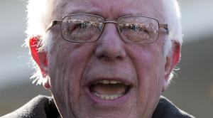 Media is reflected in the glasses of Democratic presidential candidate Sen. Bernie Sanders, I-Vt., as he speaks outside the West Wing of the White House in Washington, Wednesday, Jan. 27, 2016. after meeting with President Barack Obama. (AP Photo/Carolyn Kaster)