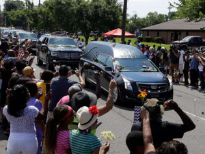 The funeral procession for Muhammad Ali makes its way down Muhammad Ali Boulevard in Louisville, Ky. Friday, June 10, 2016. (AP Photo/Michael Conroy)